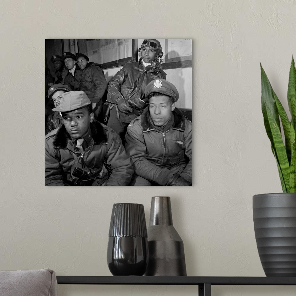 A modern room featuring A group of Tuskegee Airmen attending a briefing at Ramitella Airfield in Italy, March 1945. Left ...