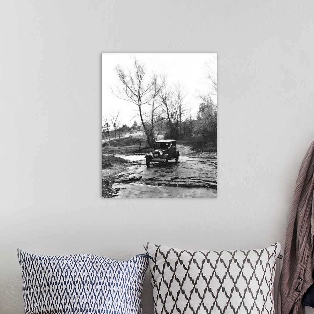 A bohemian room featuring A Model A Ford crossing a creek bed in Oldham County, Kentucky. Photograph, 1930.
