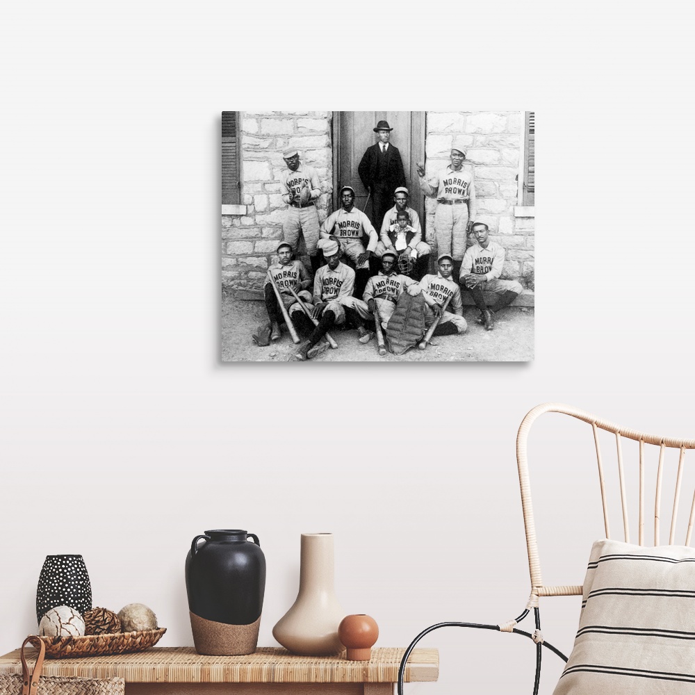 A farmhouse room featuring A late 19th century photograph of baseball players from Morris Brown College, Georgia, exhibited ...