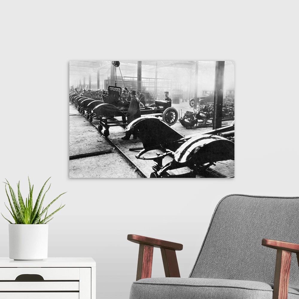A modern room featuring An American auto assembly line, c1910.