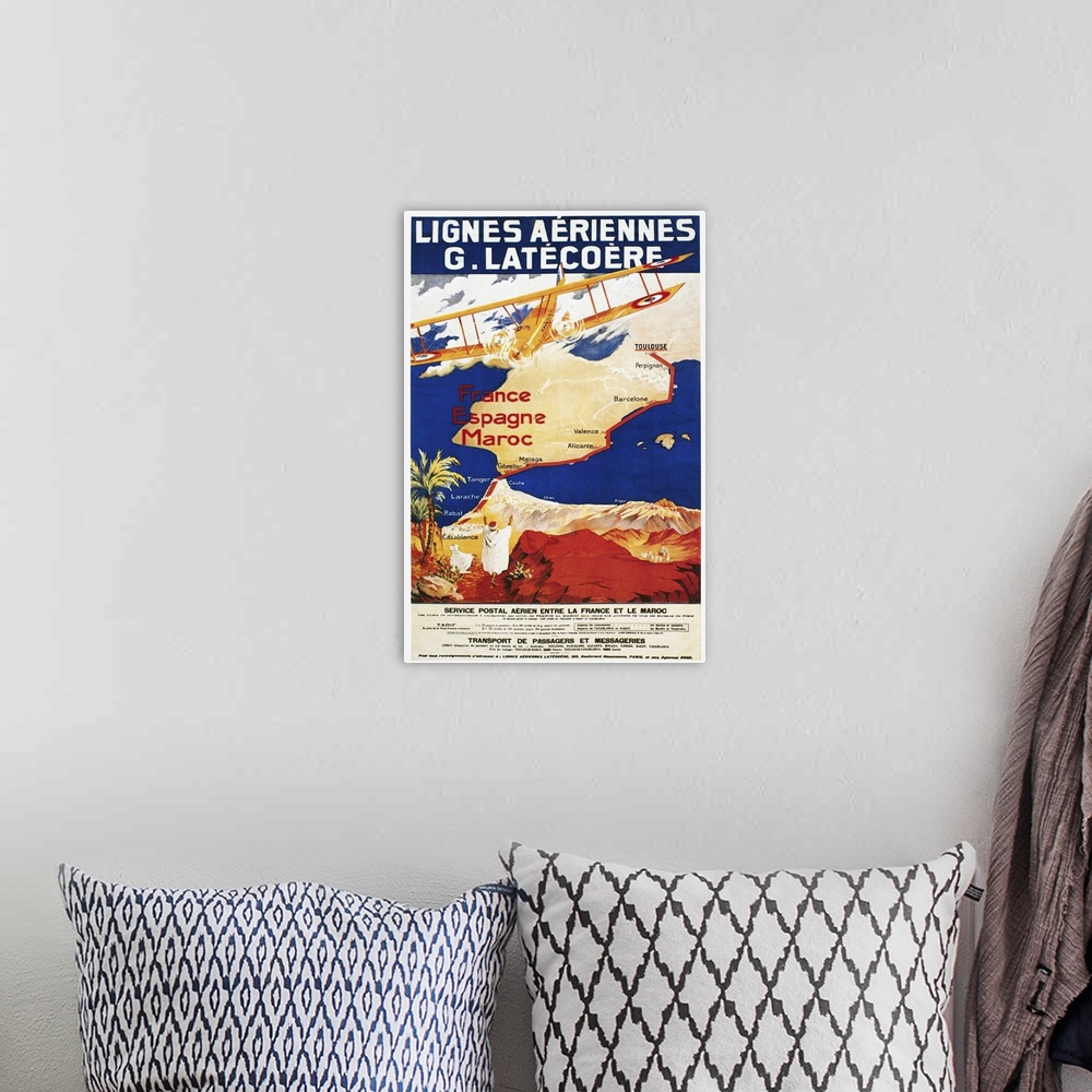 A bohemian room featuring A poster for the French airline Lat?co?re, promoting its air mail and passenger service to Spain ...