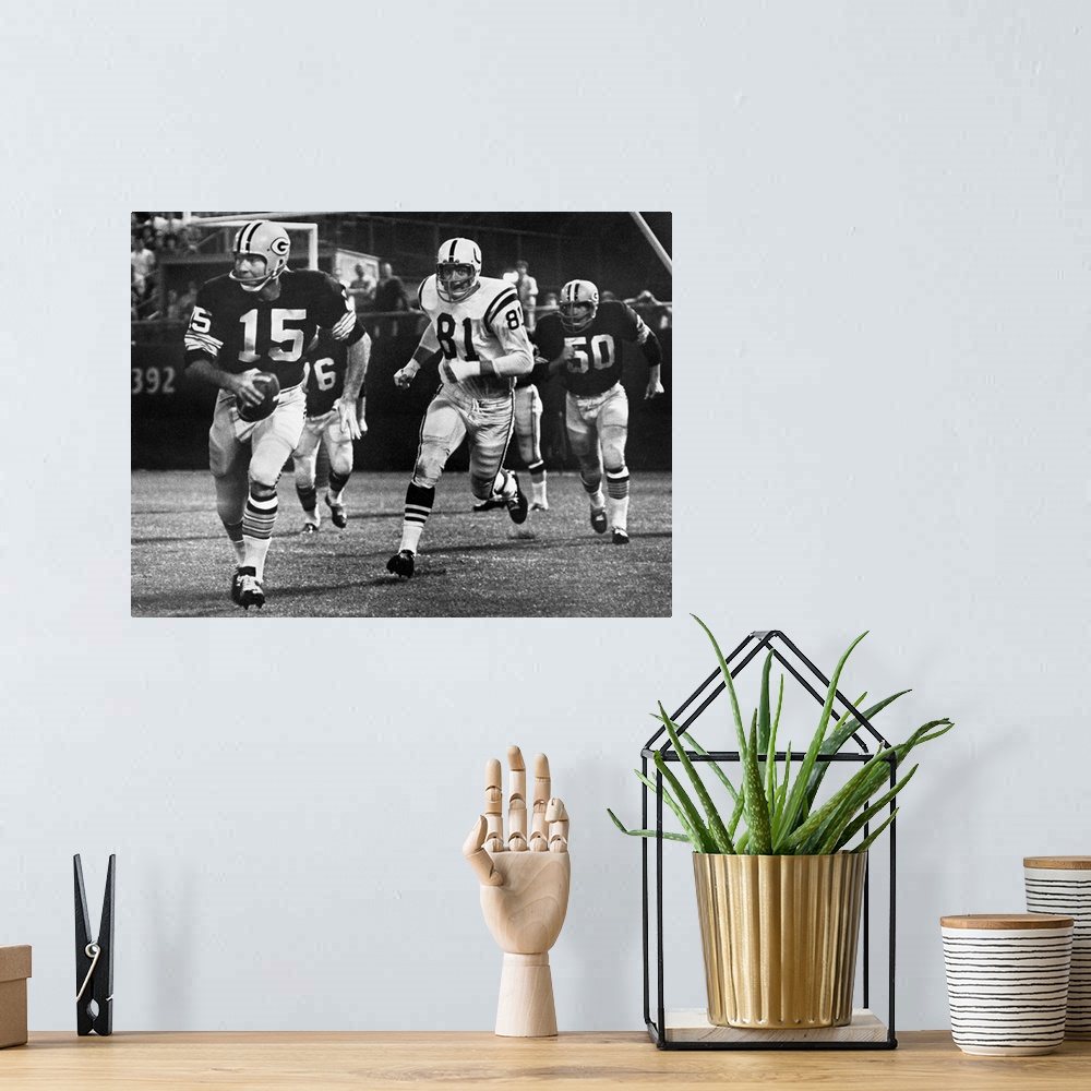 A bohemian room featuring Quarterback Bart Starr of the Green Bay Packers attempting to run for a first down against the Ba...