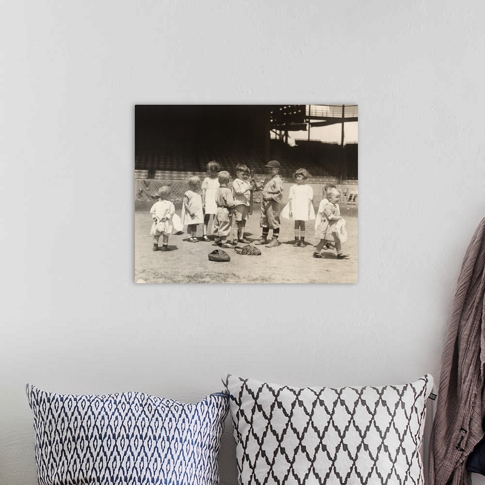 A bohemian room featuring Young boys and girls on a baseball field at a major league stadium. Photograph, early 20th century.