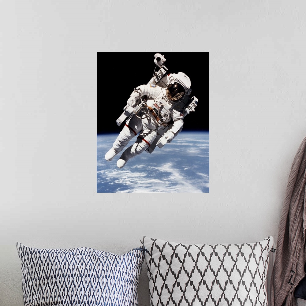 A bohemian room featuring Bruce McCandless floating free from spacecraft in orbit, 1984