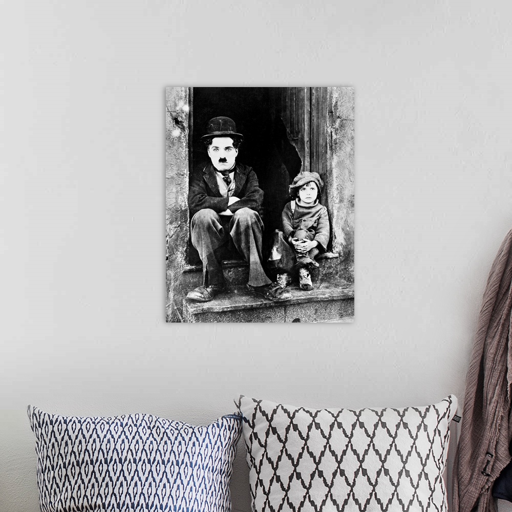 A bohemian room featuring Charlie Chaplin and Jackie Coogan as his adopted son in Chaplin's film 'The Kid,' 1921.