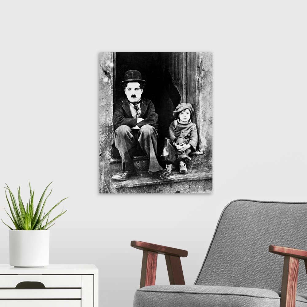A modern room featuring Charlie Chaplin and Jackie Coogan as his adopted son in Chaplin's film 'The Kid,' 1921.