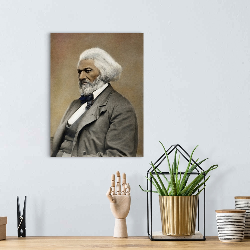 A bohemian room featuring FREDERICK DOUGLASS(c1817-1895). American abolitionist and writer. Oil over a photograph, c1885.