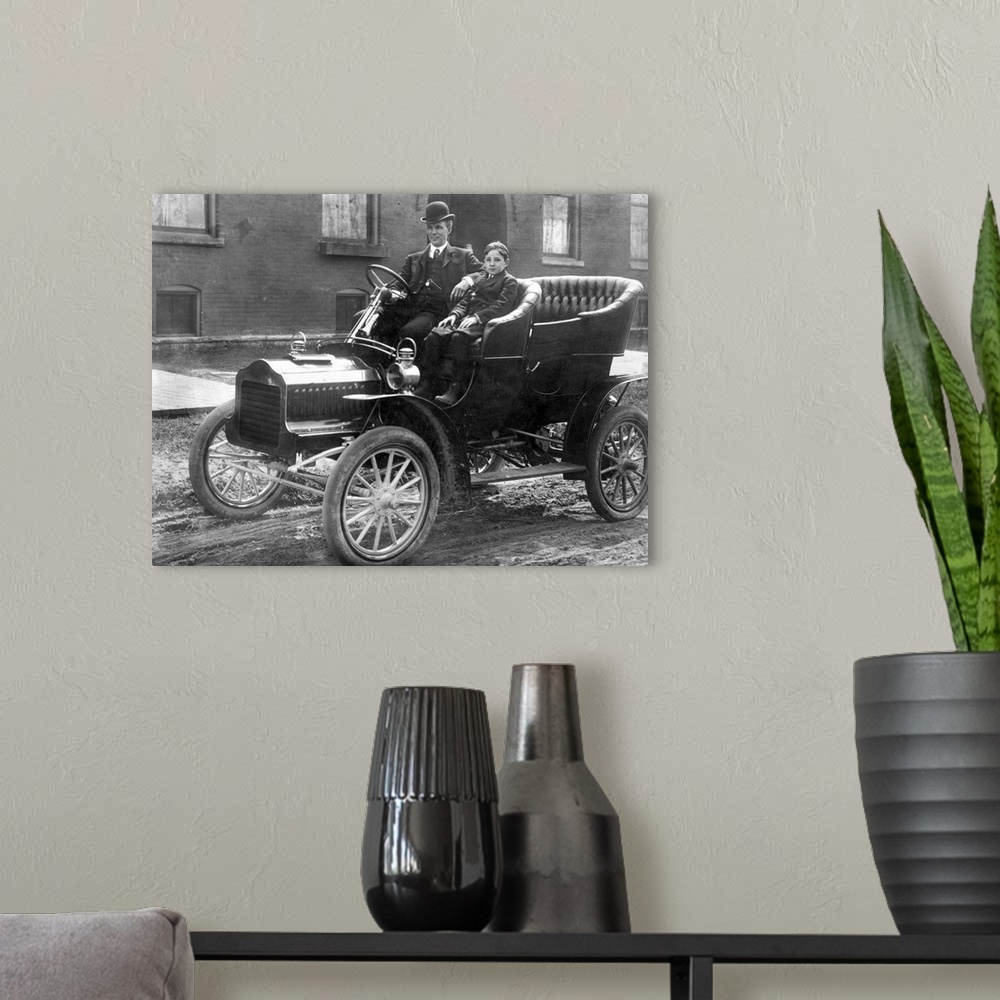 A modern room featuring with his son Edsel in a 1905 Model F Ford in front of their home on Hendrie Avenue in Detroit.