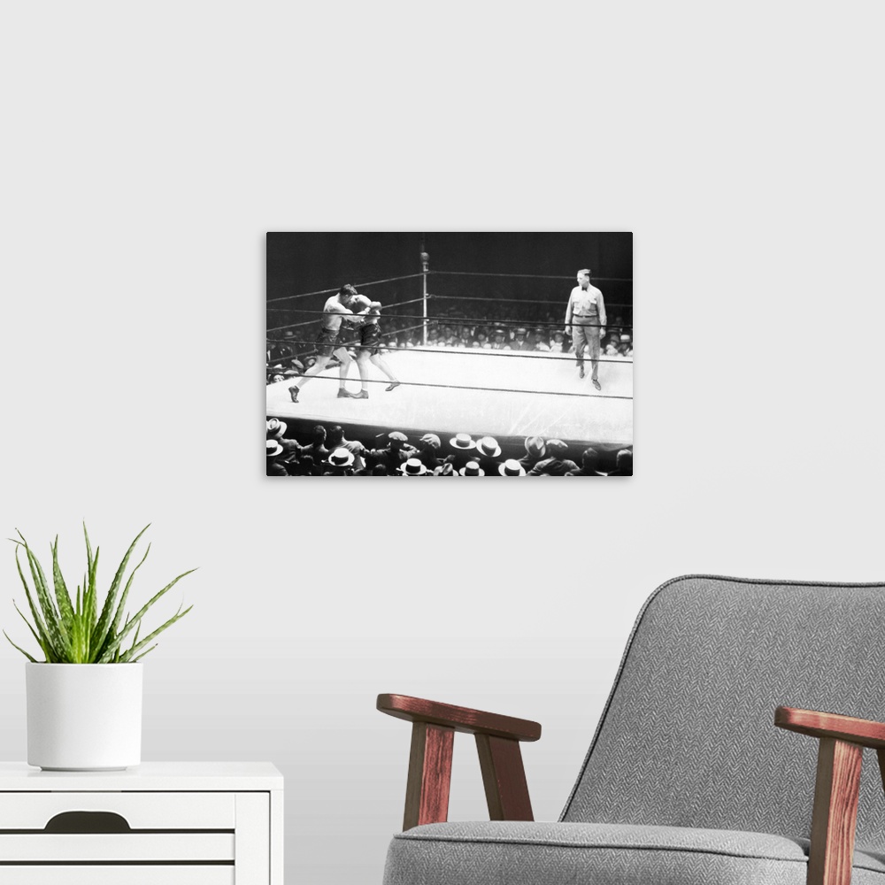 A modern room featuring American boxer. Jack Dempsey and Jack Sharkey in the second round of their heavyweight boxing mat...