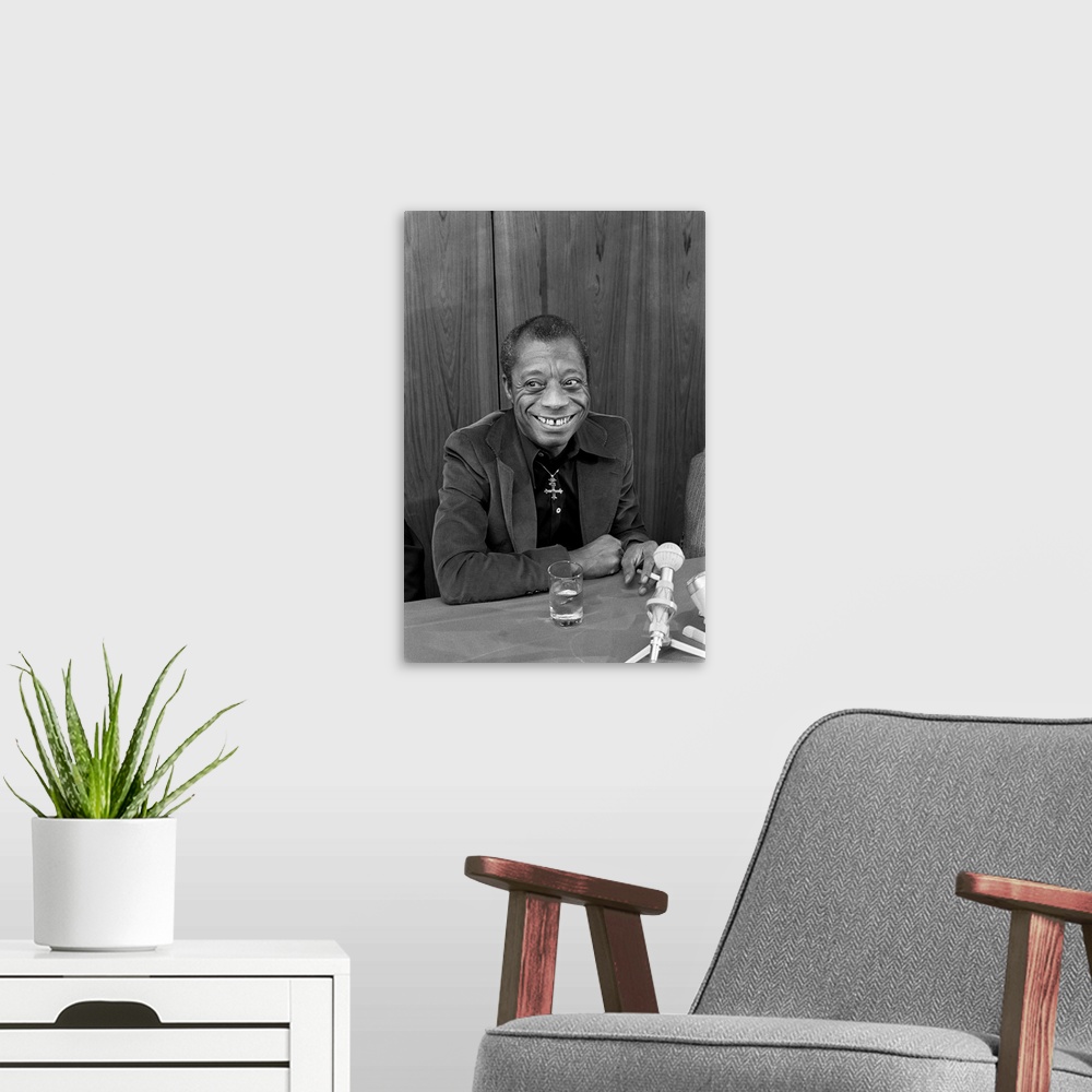 A modern room featuring JAMES BALDWIN (1924-1987). American writer.  Photographed during a press conference for his new b...