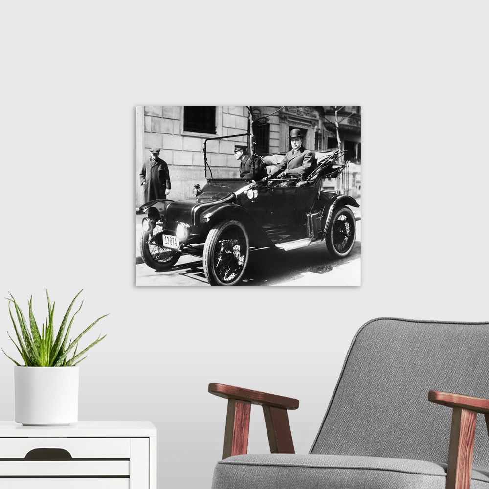 A modern room featuring (1839-1937). American oil magnate. Photographed in his electric car, 1920.