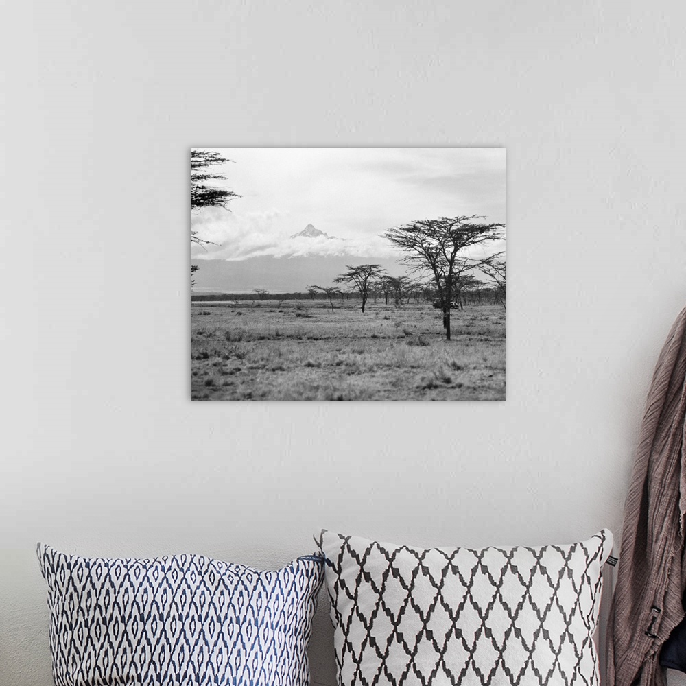 A bohemian room featuring Landscape view in Kenya, with Mount Kenya seen in the distance. Photographed in 1936.