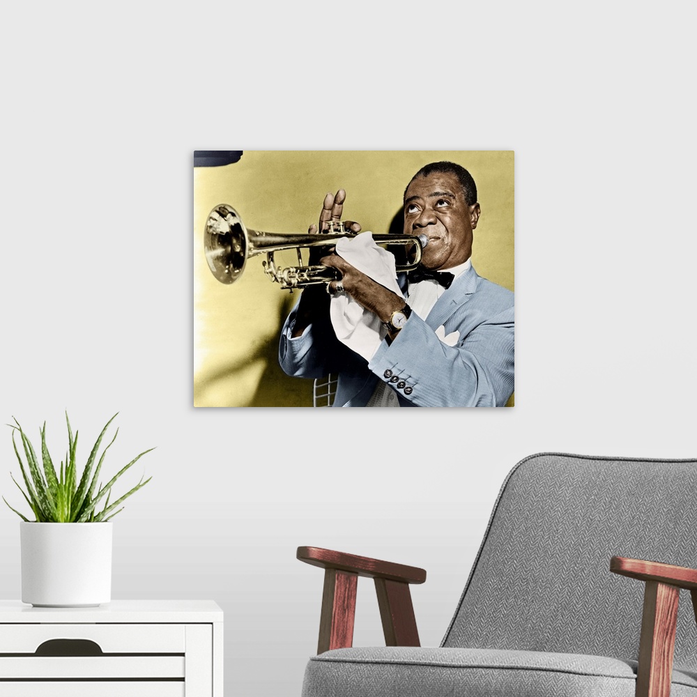 A modern room featuring LOUIS ARMSTRONG (1900-1971). American jazz musician. Photographed playing trumpet, 1953.