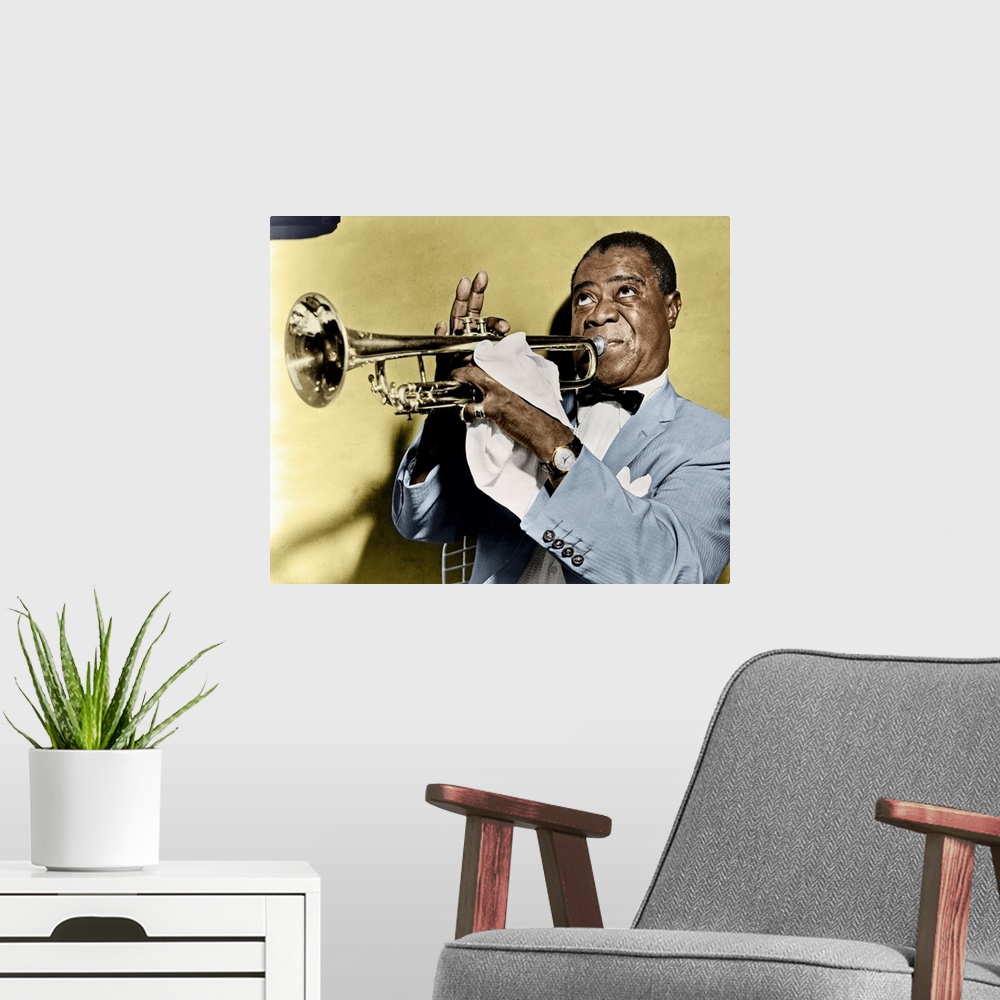 A modern room featuring LOUIS ARMSTRONG (1900-1971). American jazz musician. Photographed playing trumpet, 1953.