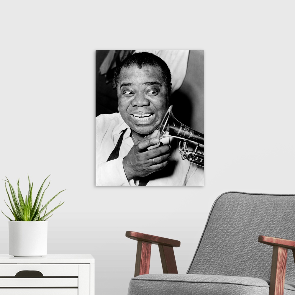A modern room featuring LOUIS ARMSTRONG (1901-1971). American jazz musician. Photograph by Herman Hiller, 1953.