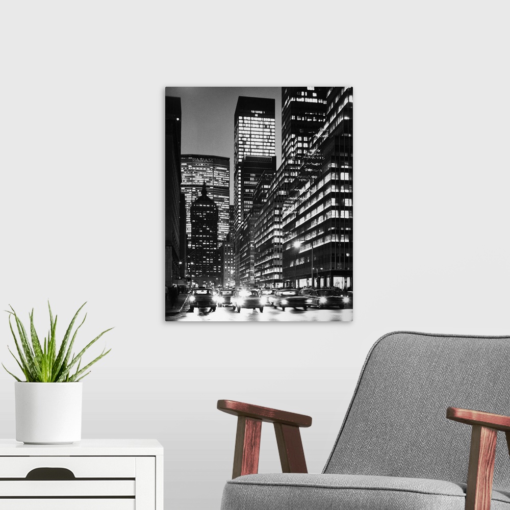 A modern room featuring A view of Park Avenue in New York City at night, including Grand Central Station, the Pan Am Buil...