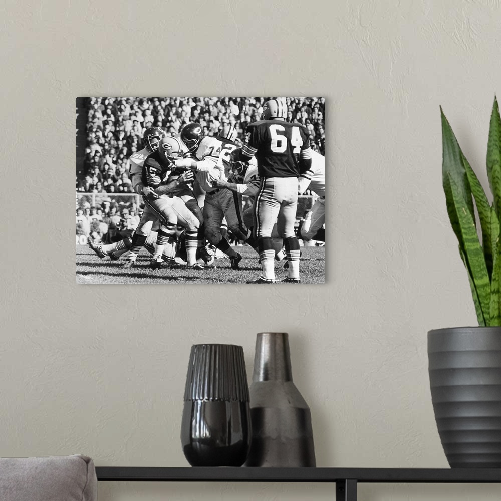 A modern room featuring Quarterback Bart Starr of the Green Bay Packers being sacked for an 11-yard loss by Dick Butkus a...