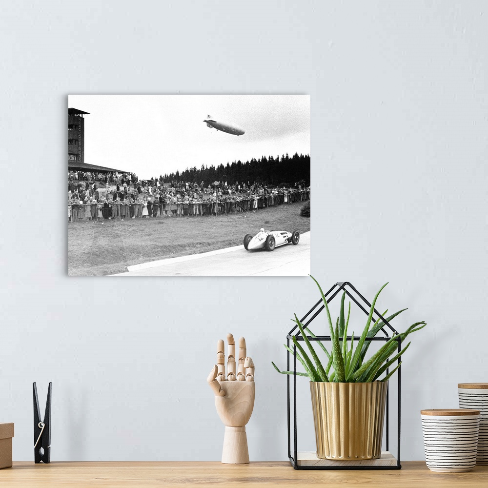 A bohemian room featuring (1901-1958). German racing driver. The airship Graf Zeppelin hovers above the crowd at Nuremberg,...