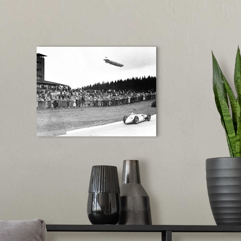 A modern room featuring (1901-1958). German racing driver. The airship Graf Zeppelin hovers above the crowd at Nuremberg,...