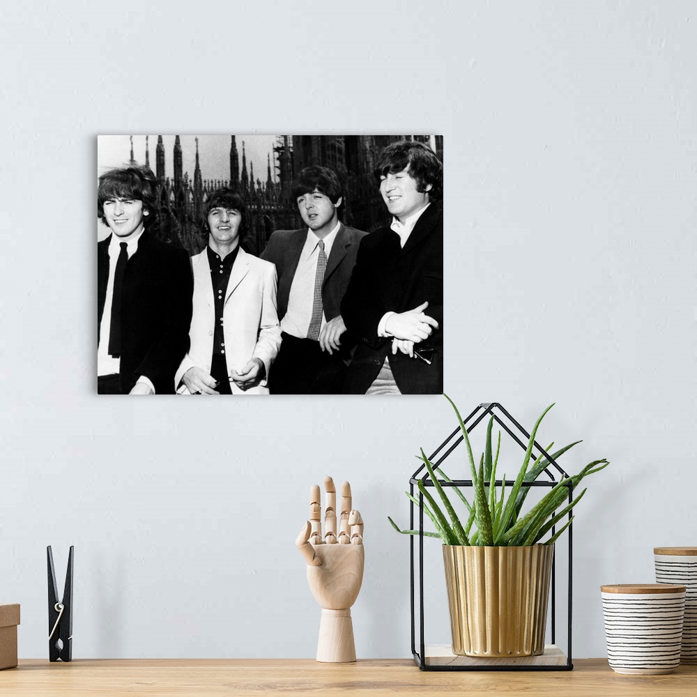A bohemian room featuring The Beatles in Milan, Italy. Photograph, 1965. Left to right: George Harrison, Ringo Starr, Paul ...