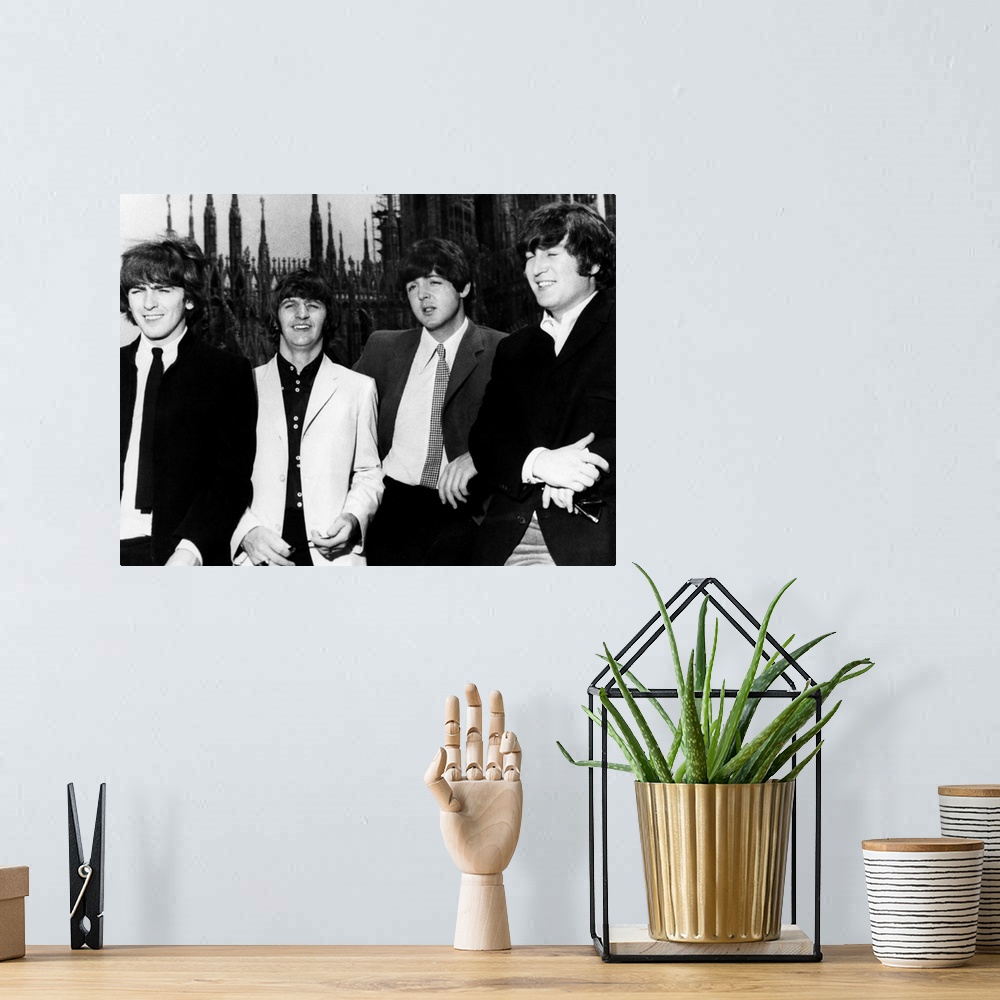 A bohemian room featuring The Beatles in Milan, Italy. Photograph, 1965. Left to right: George Harrison, Ringo Starr, Paul ...