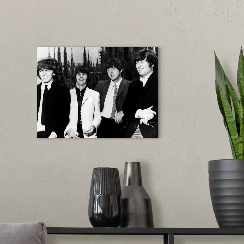 A modern room featuring The Beatles in Milan, Italy. Photograph, 1965. Left to right: George Harrison, Ringo Starr, Paul ...