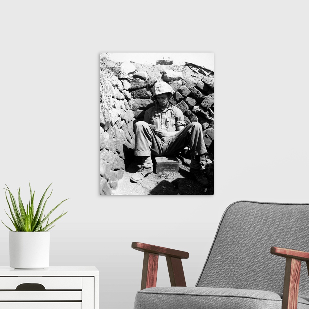 A modern room featuring Portrait of U.S. Marine PFC Keith A. Cole sitting in a foxhole on Iwo Jima. Photograph, 1 March 1...