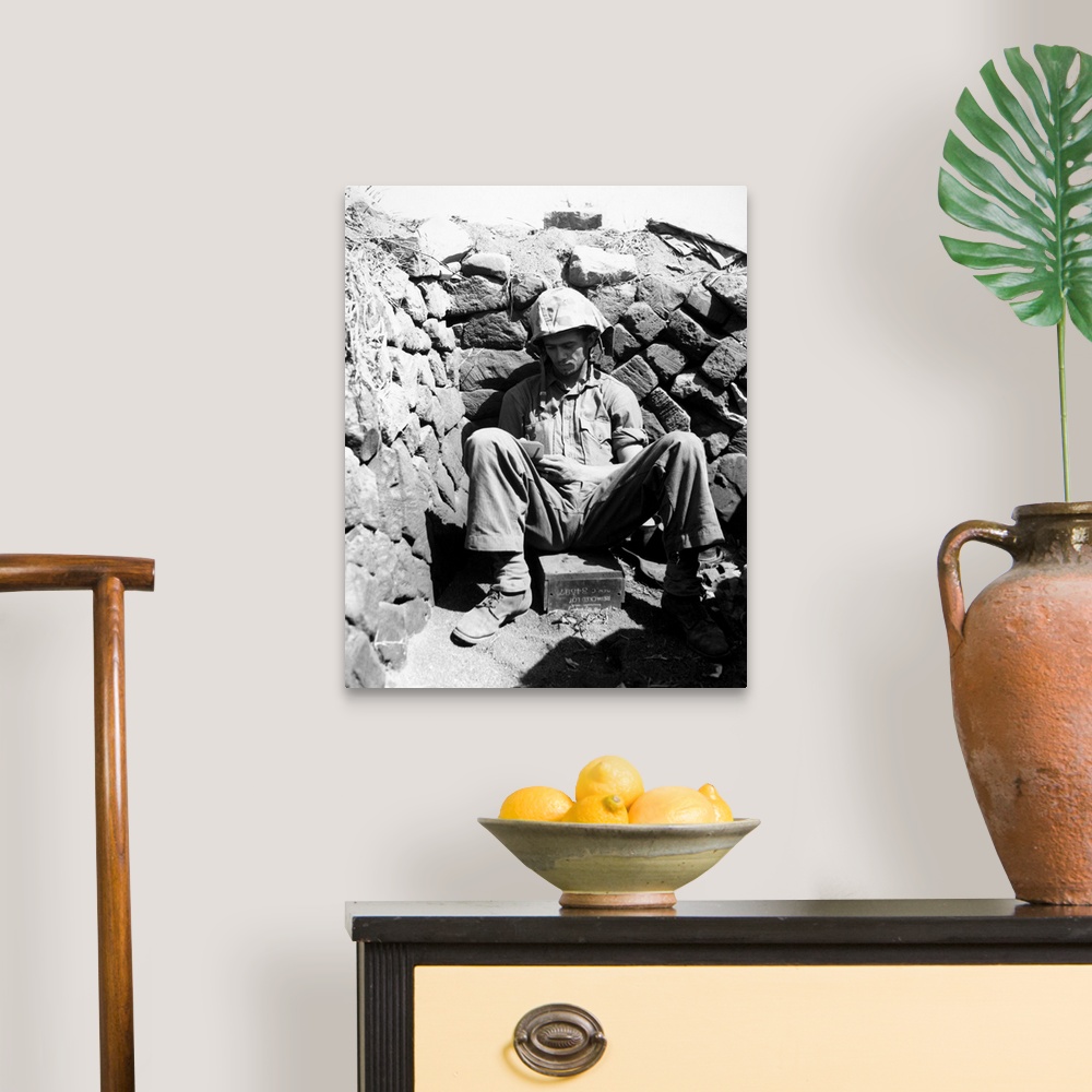 A traditional room featuring Portrait of U.S. Marine PFC Keith A. Cole sitting in a foxhole on Iwo Jima. Photograph, 1 March 1...