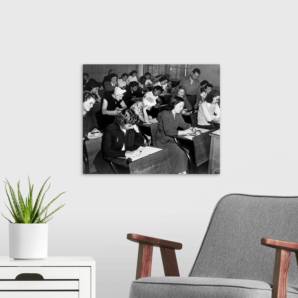 A modern room featuring Women taking the qualifying exam for the New York City Police Department. Photograph by Dick De M...