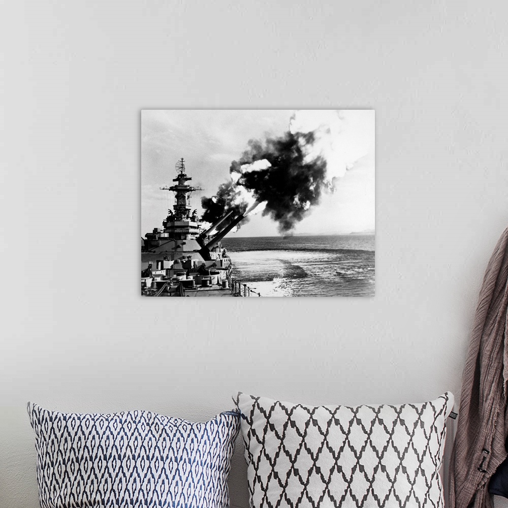 A bohemian room featuring An American battleship firing its guns during World War II.