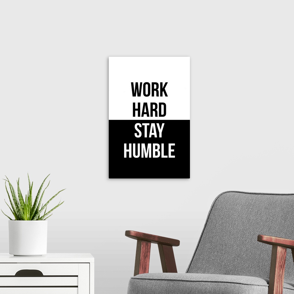 A modern room featuring "Work Hard, Stay Humble" in black and white.