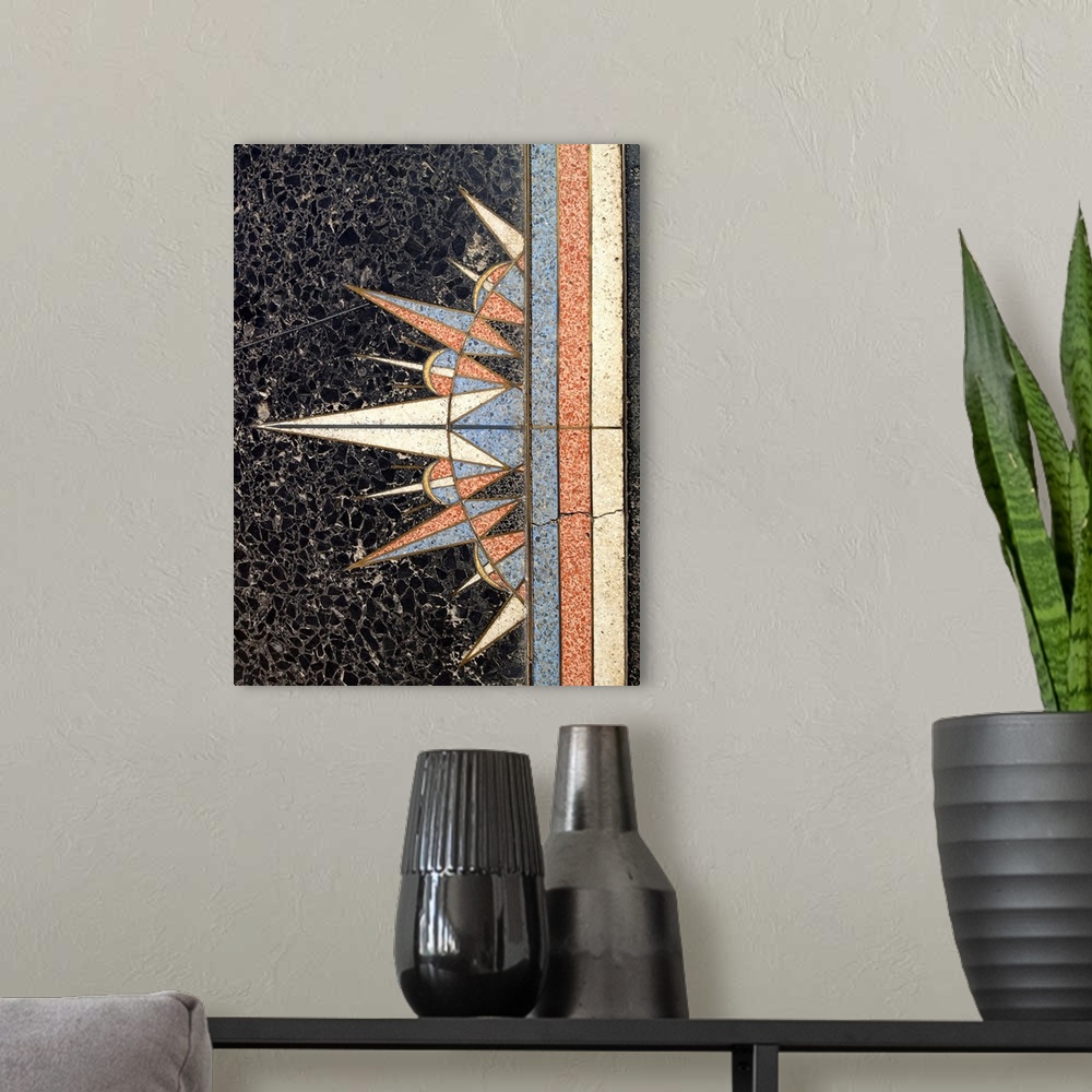 A modern room featuring Photograph of a multi-colored marble art decro wall design of a sun.