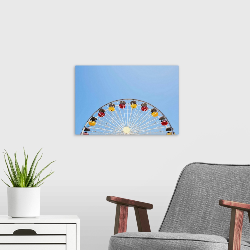 A modern room featuring Photograph of a yellow and red Ferris Wheel against a bright, clear, blue sky.