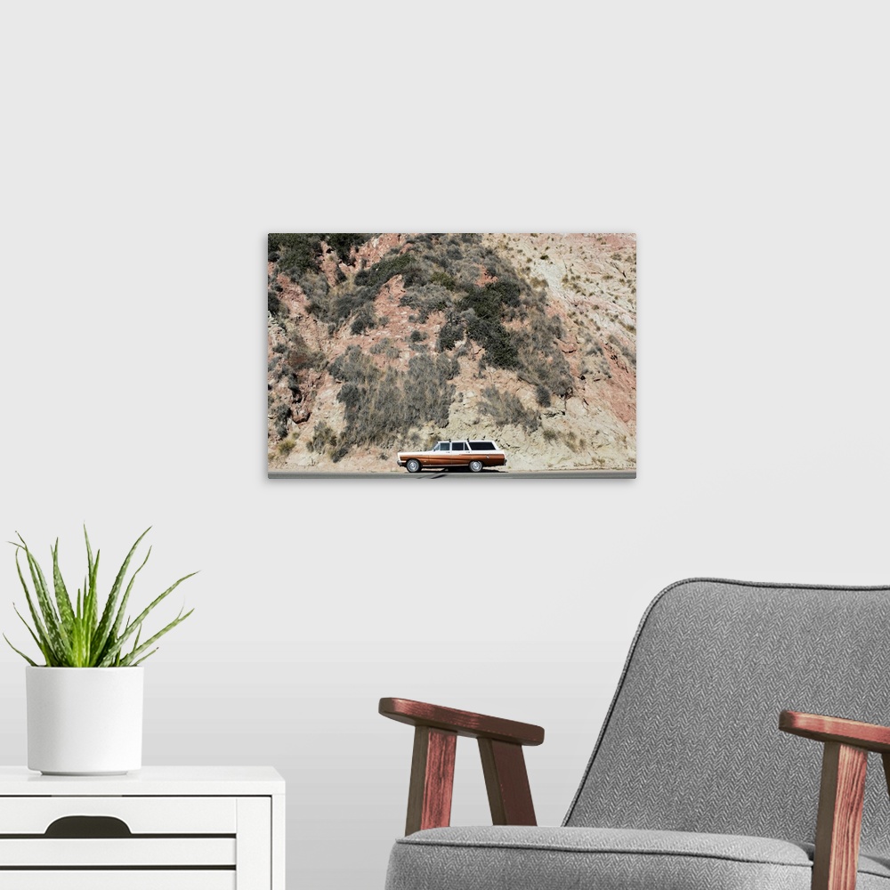 A modern room featuring Photograph of a vintage station wagon sitting on the side of a road next to a rocky hill.