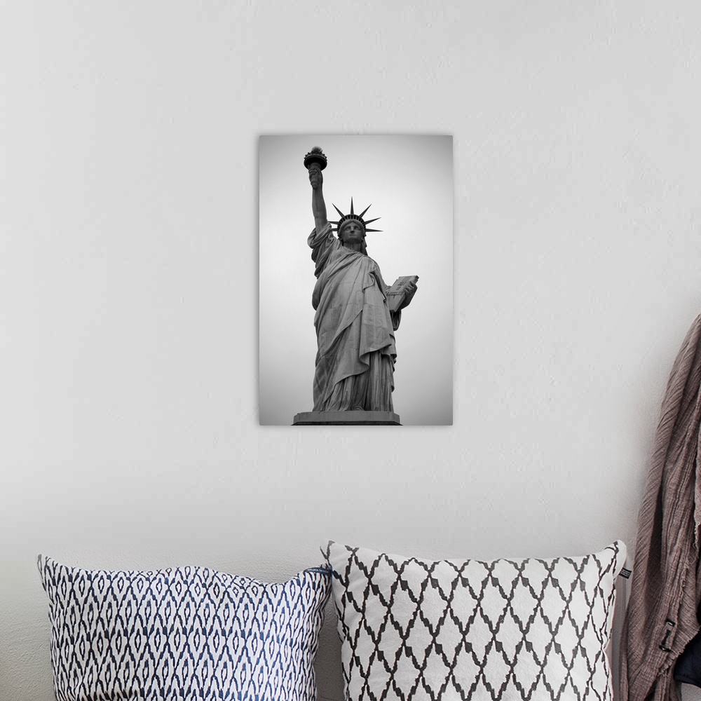 A bohemian room featuring A black and white photograph of the Statue of Liberty.