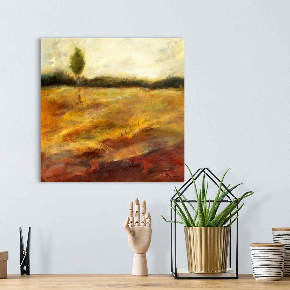 A bohemian room featuring Contemporary painting of a golden earthy toned landscape with a small lone tree in the distance.