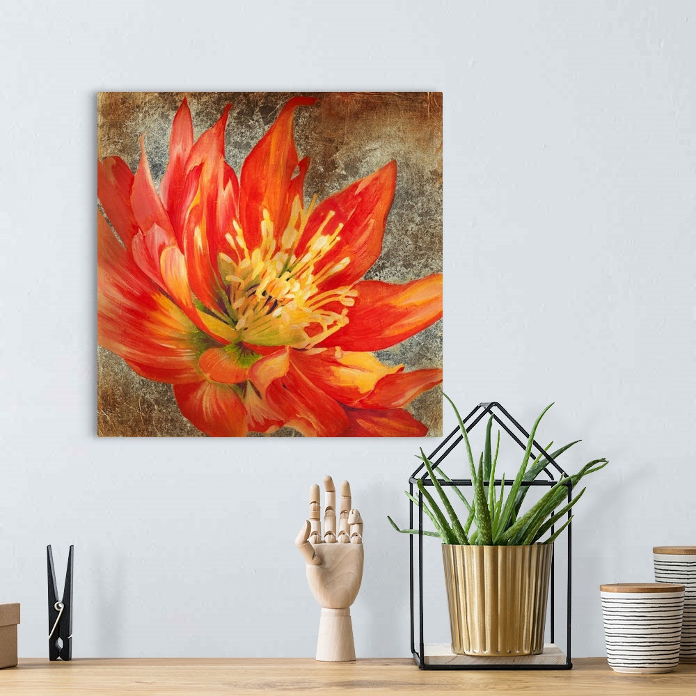 A bohemian room featuring Square artwork of a large red flower with yellow details on a metallic bronze background.