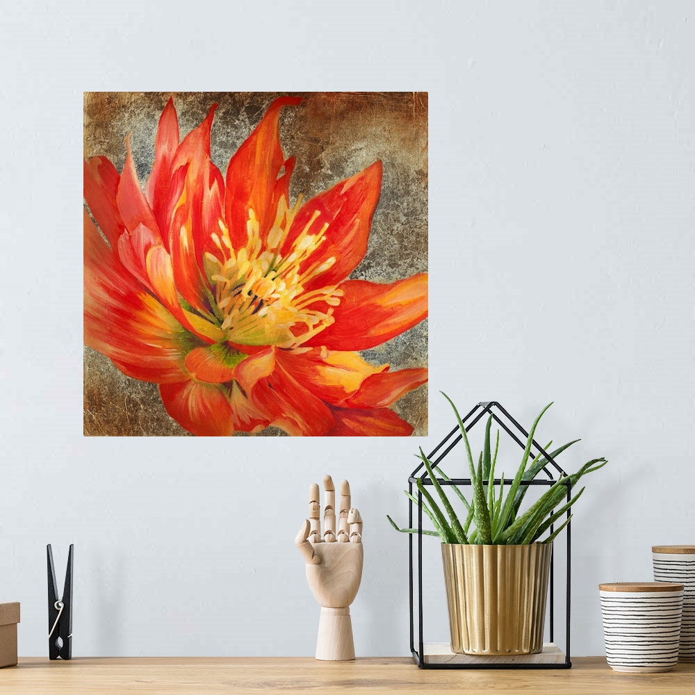 A bohemian room featuring Square artwork of a large red flower with yellow details on a metallic bronze background.