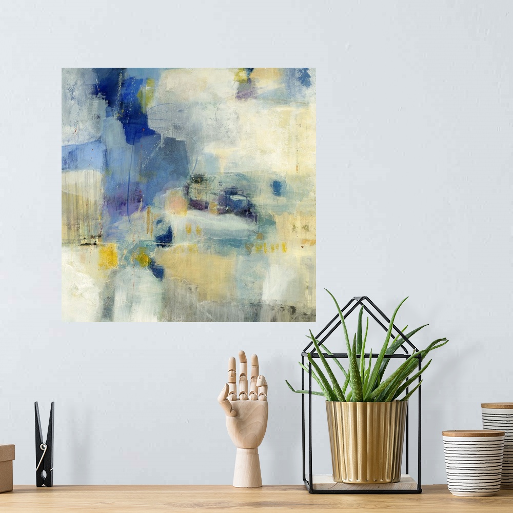 A bohemian room featuring Contemporary abstract painting using splashes of blue and yellow against a beige background.