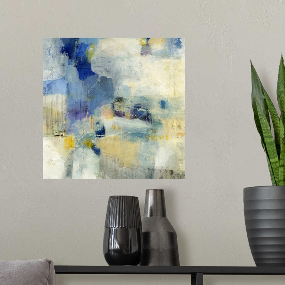 A modern room featuring Contemporary abstract painting using splashes of blue and yellow against a beige background.