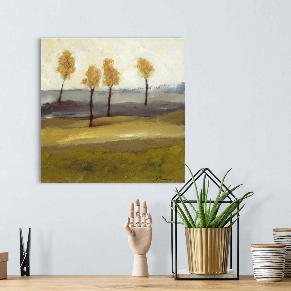 A bohemian room featuring Contemporary landscape painting with four trees in autumn foliage standing together in the distance.