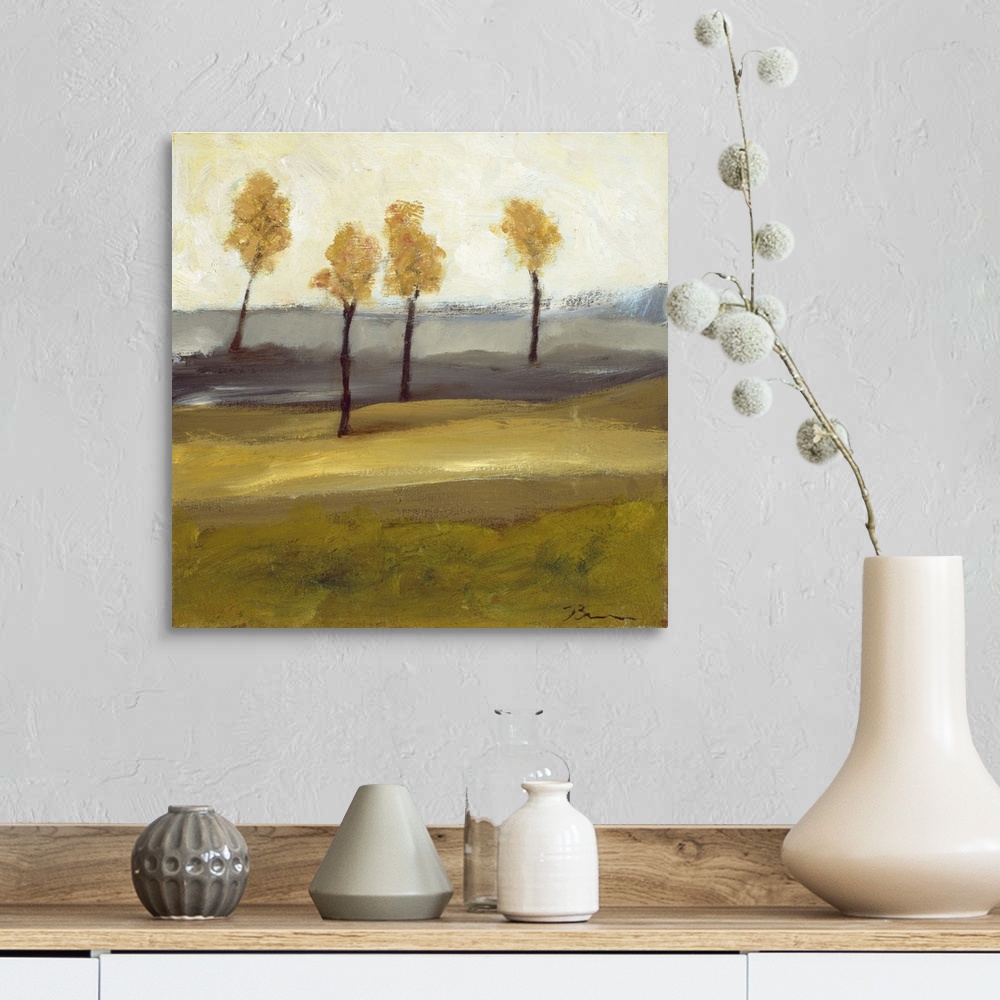A farmhouse room featuring Contemporary landscape painting with four trees in autumn foliage standing together in the distance.
