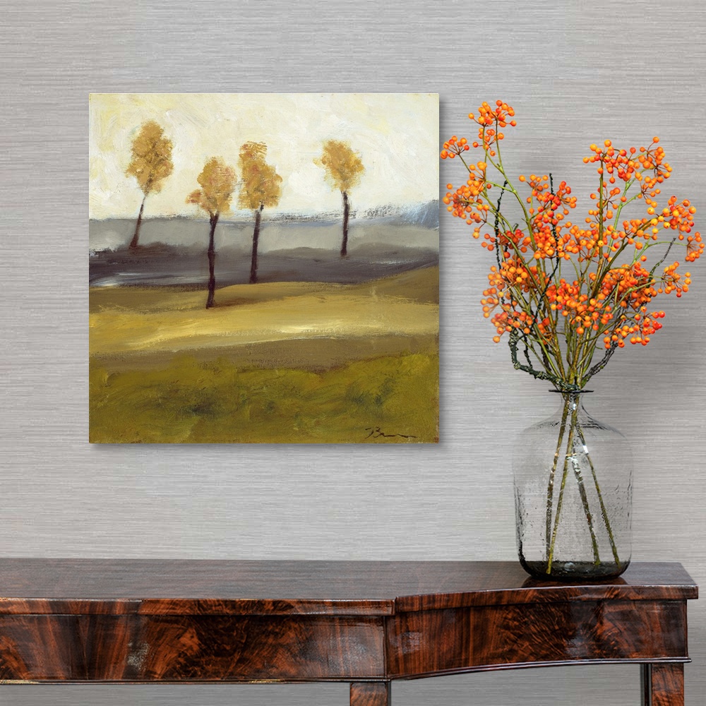 A traditional room featuring Contemporary landscape painting with four trees in autumn foliage standing together in the distance.