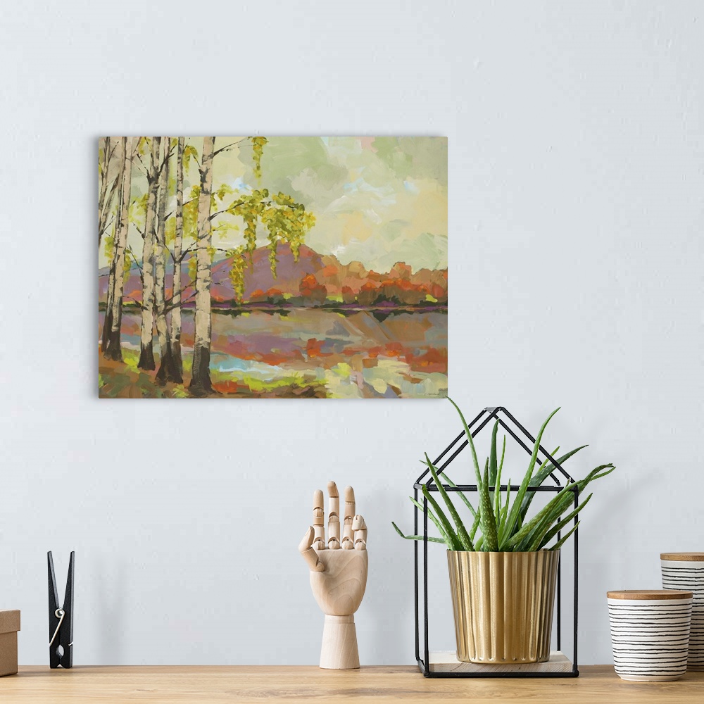 A bohemian room featuring A painting in the transitional style of birch trees by the side of a lake with mountains in the b...