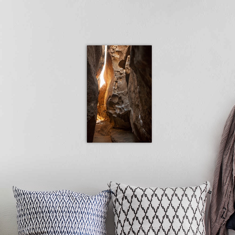 A bohemian room featuring A photograph of looking through a tight canyon.
