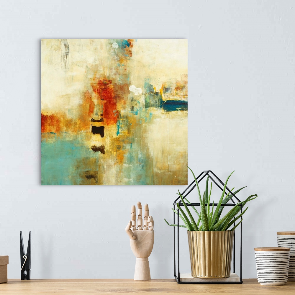 A bohemian room featuring Square abstract painting of warm tone colors of blue, orange and yellow.