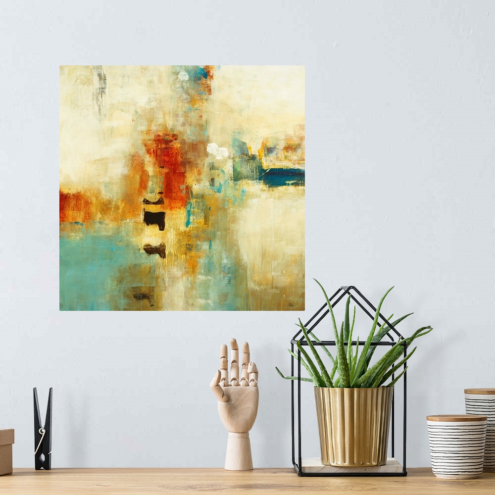 A bohemian room featuring Square abstract painting of warm tone colors of blue, orange and yellow.
