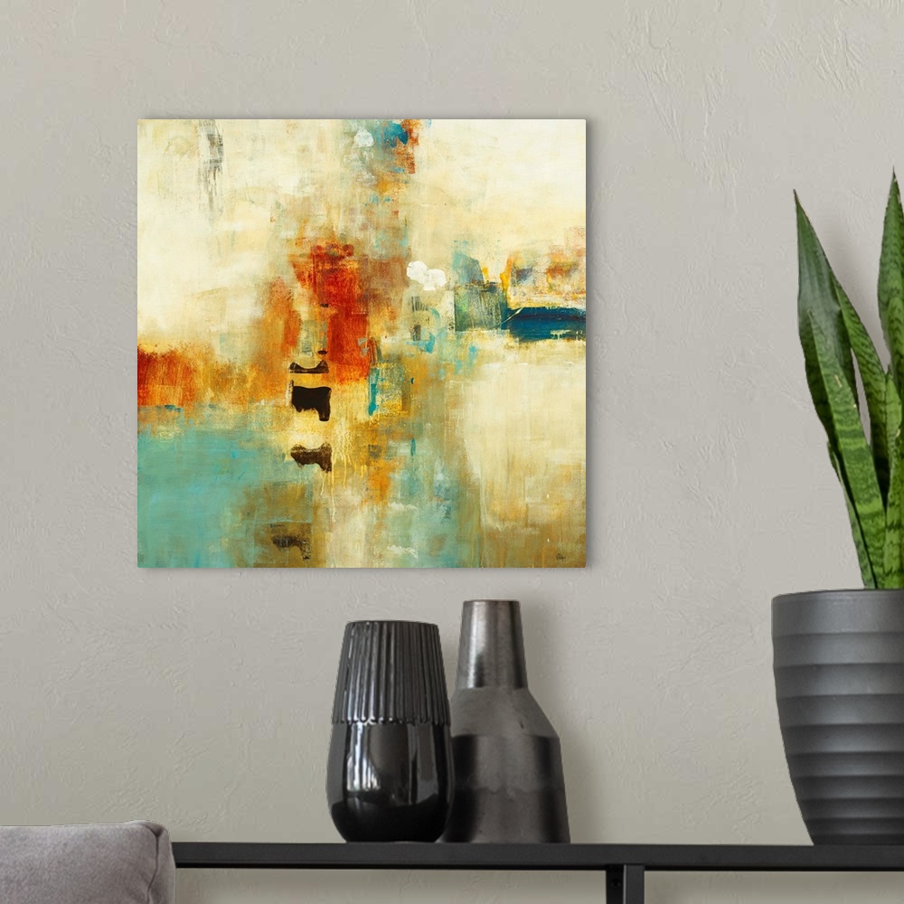 A modern room featuring Square abstract painting of warm tone colors of blue, orange and yellow.