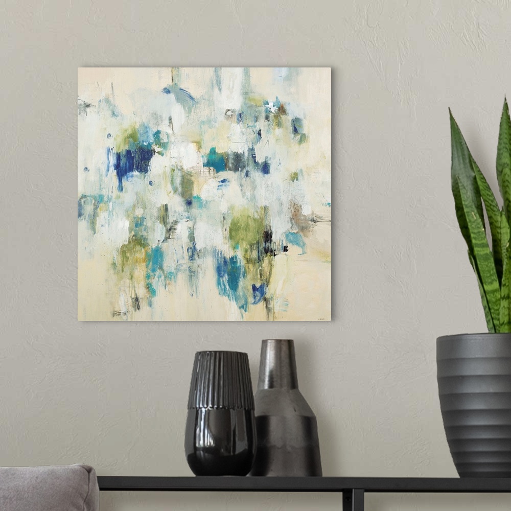 A modern room featuring Beige abstract contemporary artwork using splashes of bright color.