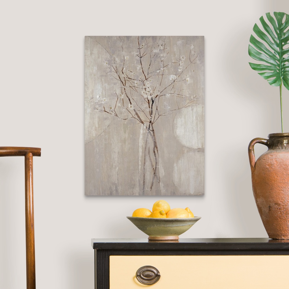 A traditional room featuring A monochromatic vertical painting of  twigs with tiny flowers.